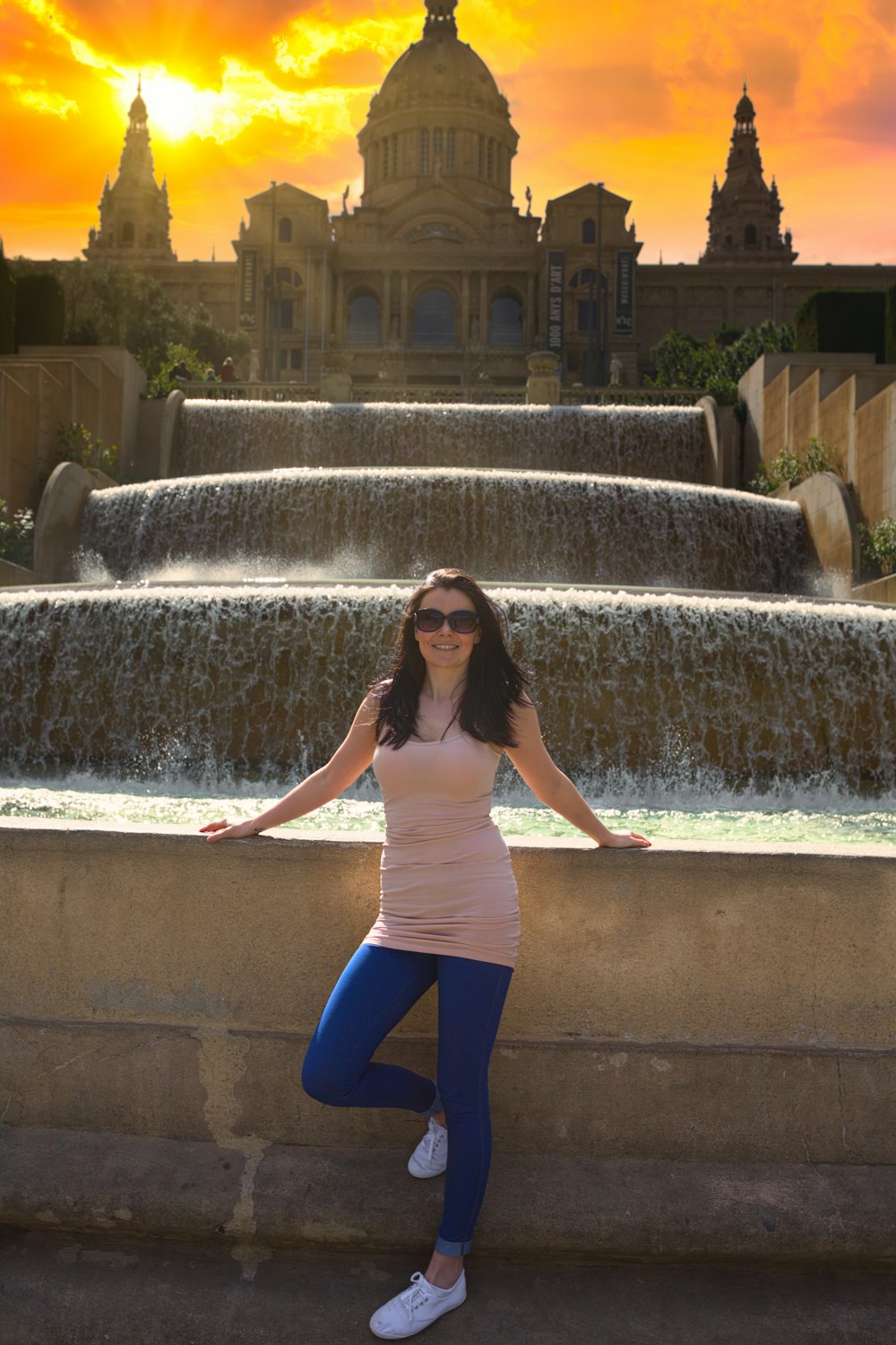 a woman posing in front of a fountain