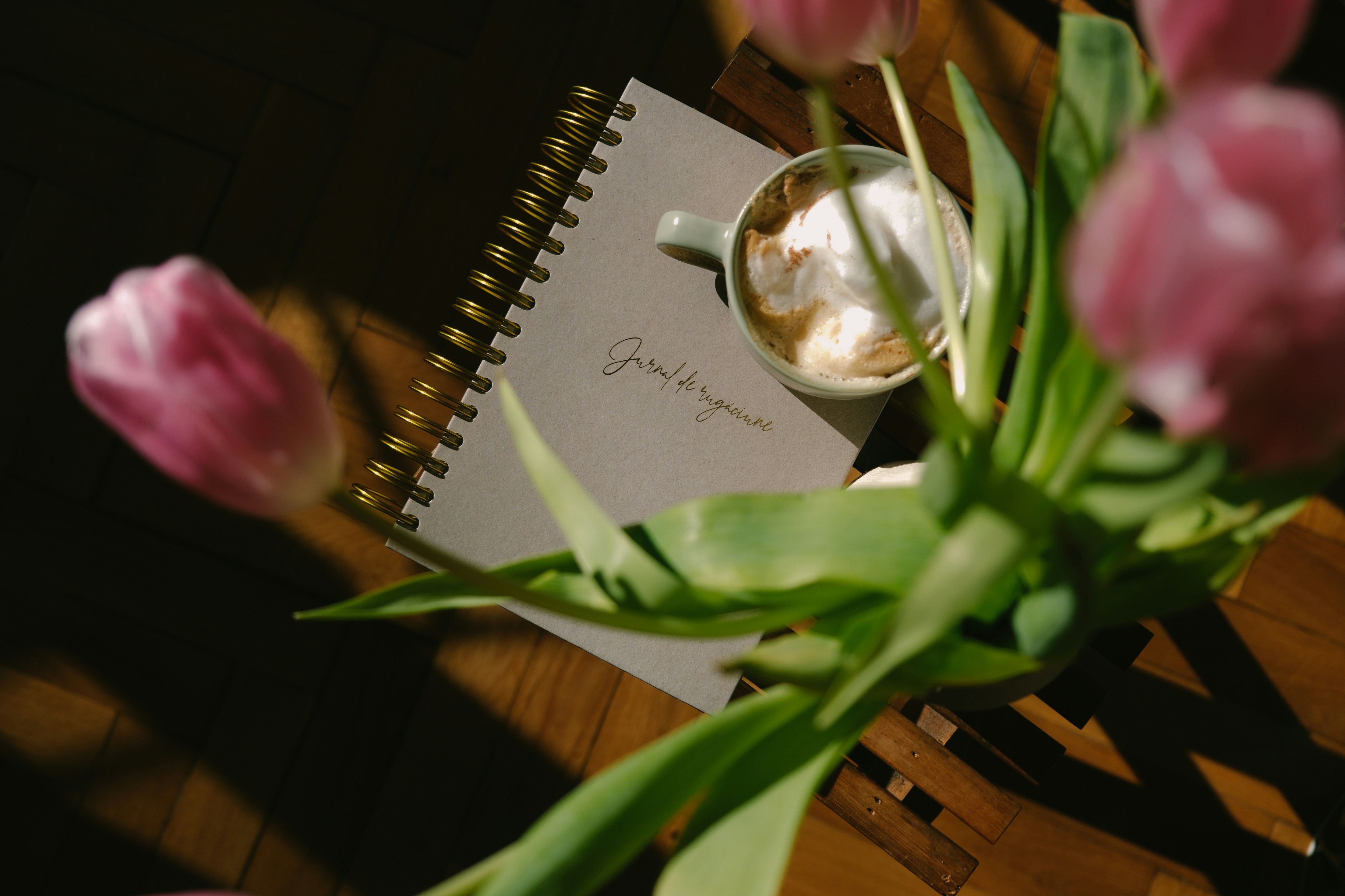 a cup of coffee and a notepad on a table
