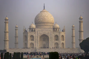 a group of people standing in front of a white building