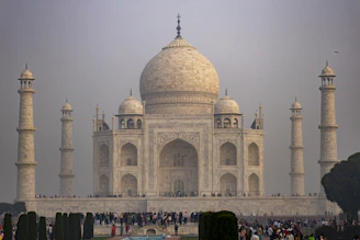 a group of people standing in front of a white building