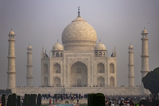 a group of people standing in front of a white building
