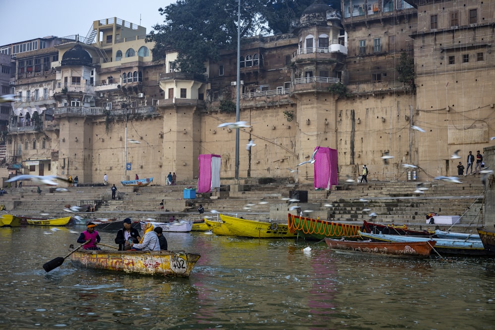 a group of people in a small boat on a body of water