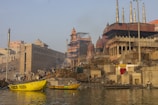 a yellow boat floating on top of a body of water