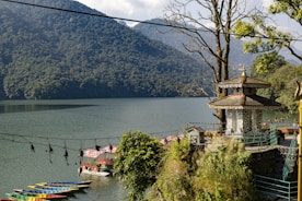a group of boats parked on the shore of a lake
