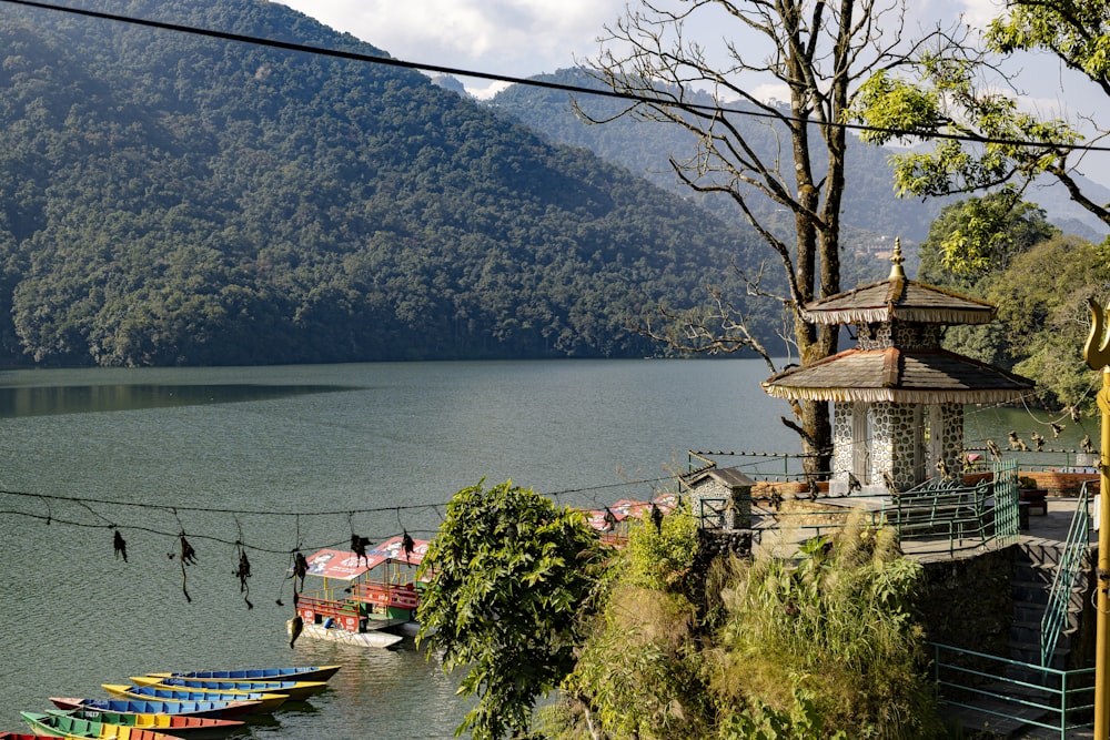 a group of boats parked on the shore of a lake