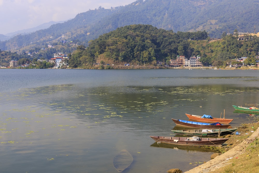 a group of boats sitting on top of a lake