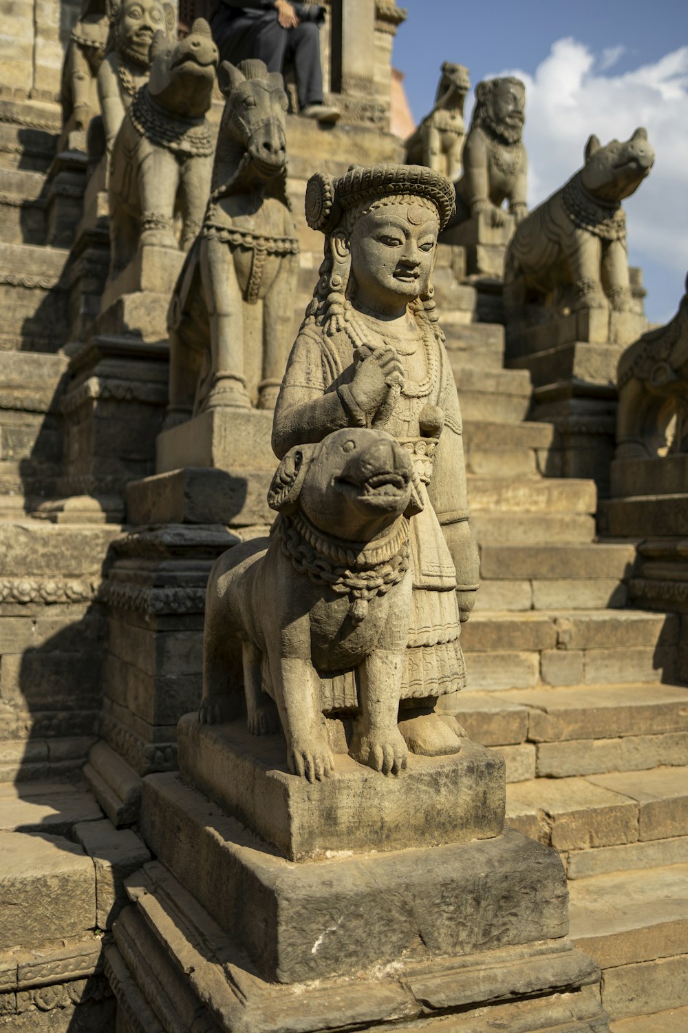 a stone statue of a woman holding a baby