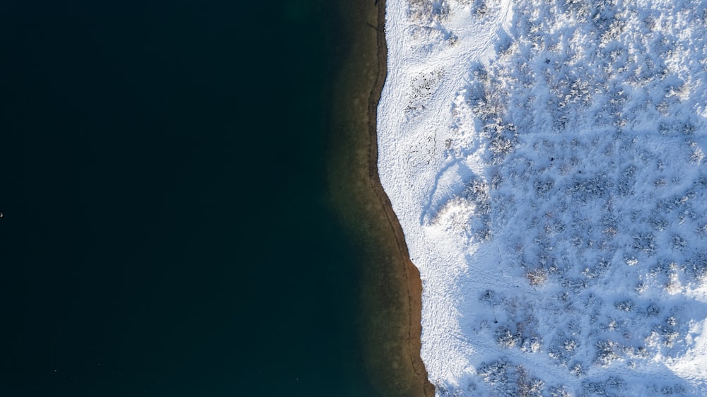 a bird's eye view of snow covered ground and water