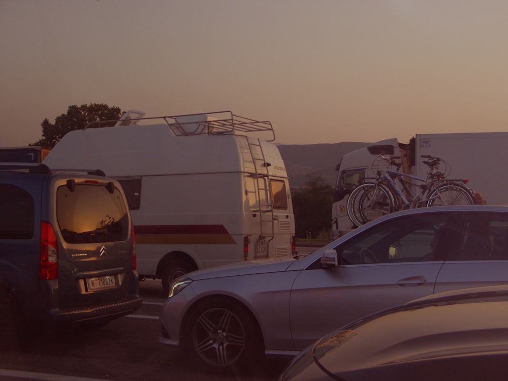 a car parked next to a camper and a van