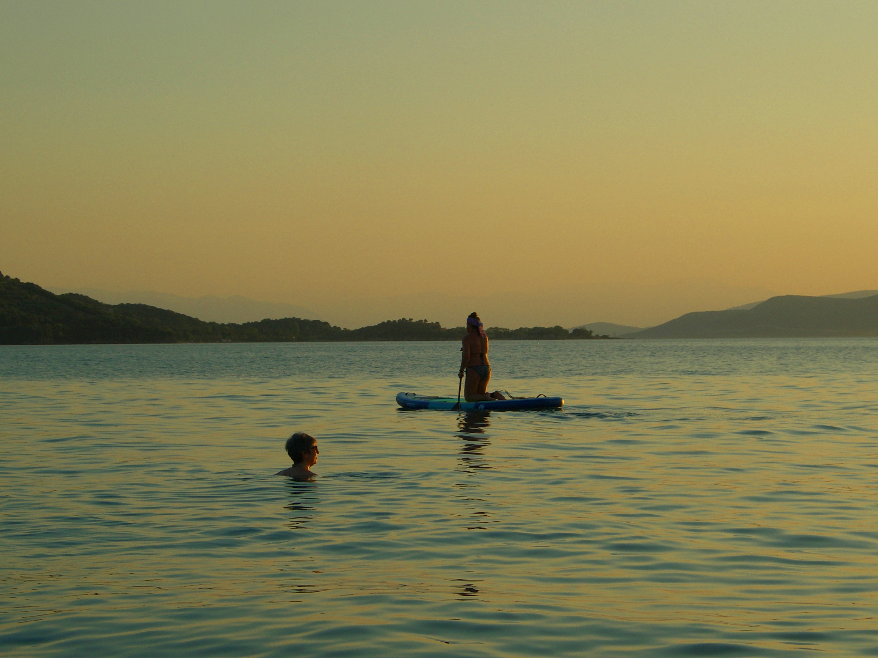 a man standing on a paddle board in the water