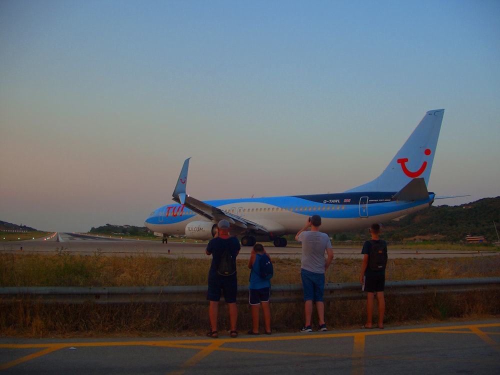 a group of people standing in front of an airplane