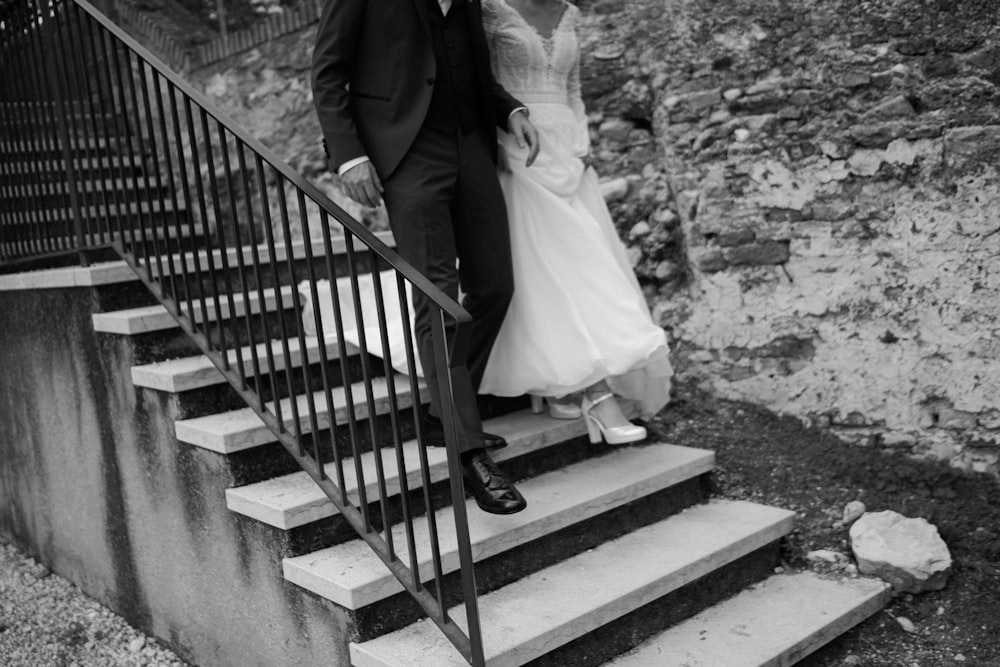 a man and a woman are standing on some stairs