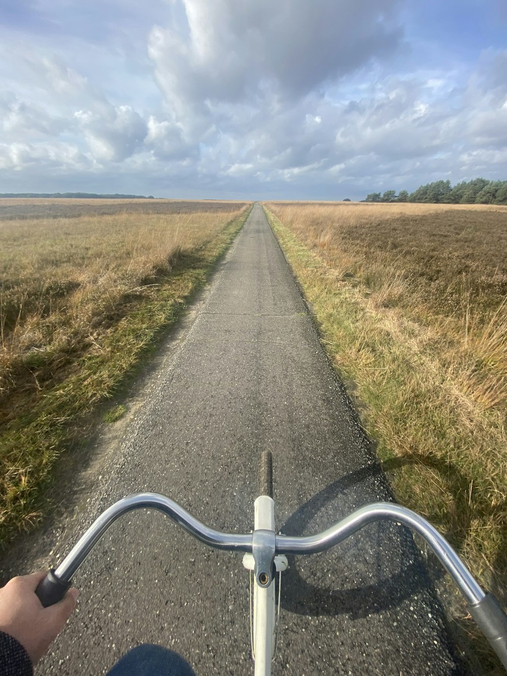 a person riding a bike down a dirt road