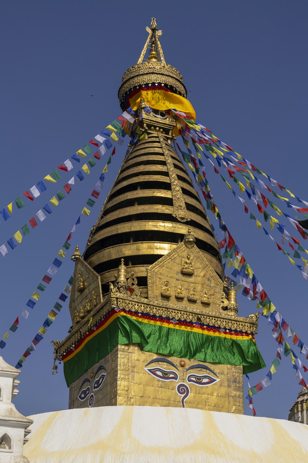 a very tall building with many colorful flags on top of it