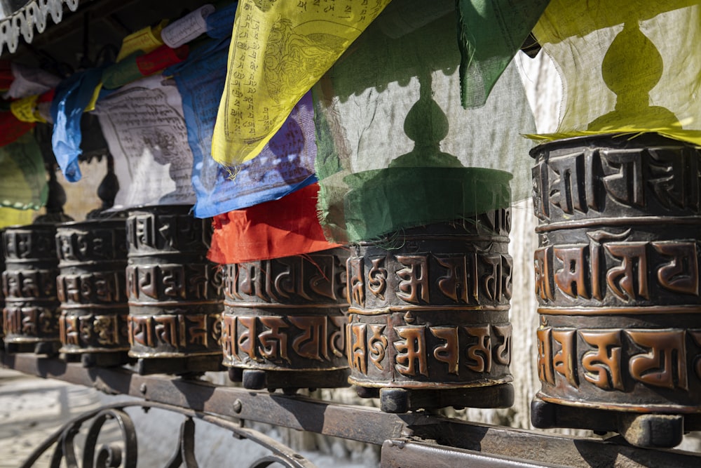 a row of bells hanging from the side of a building