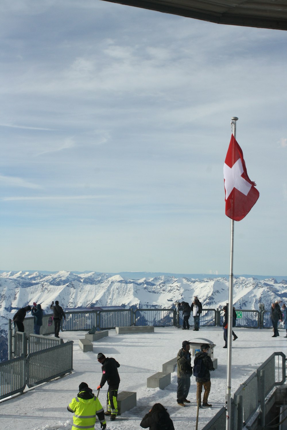 a group of people standing on top of a snow covered slope