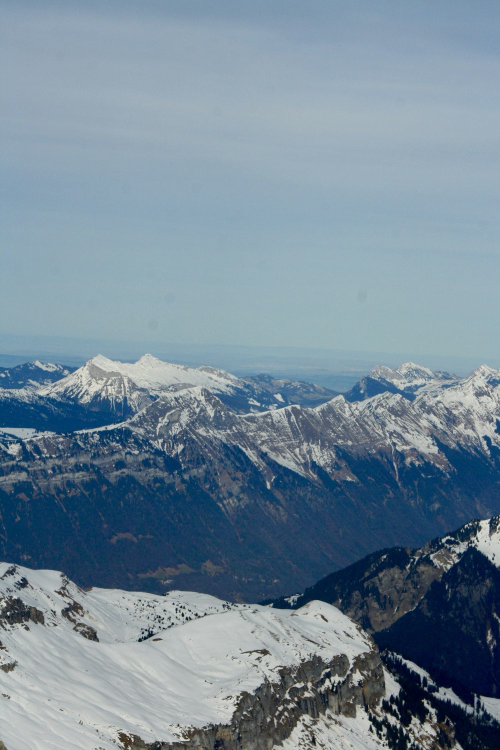 a person standing on top of a snow covered mountain