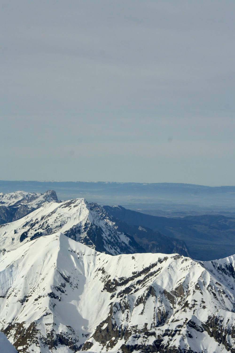 a person standing on top of a snow covered mountain