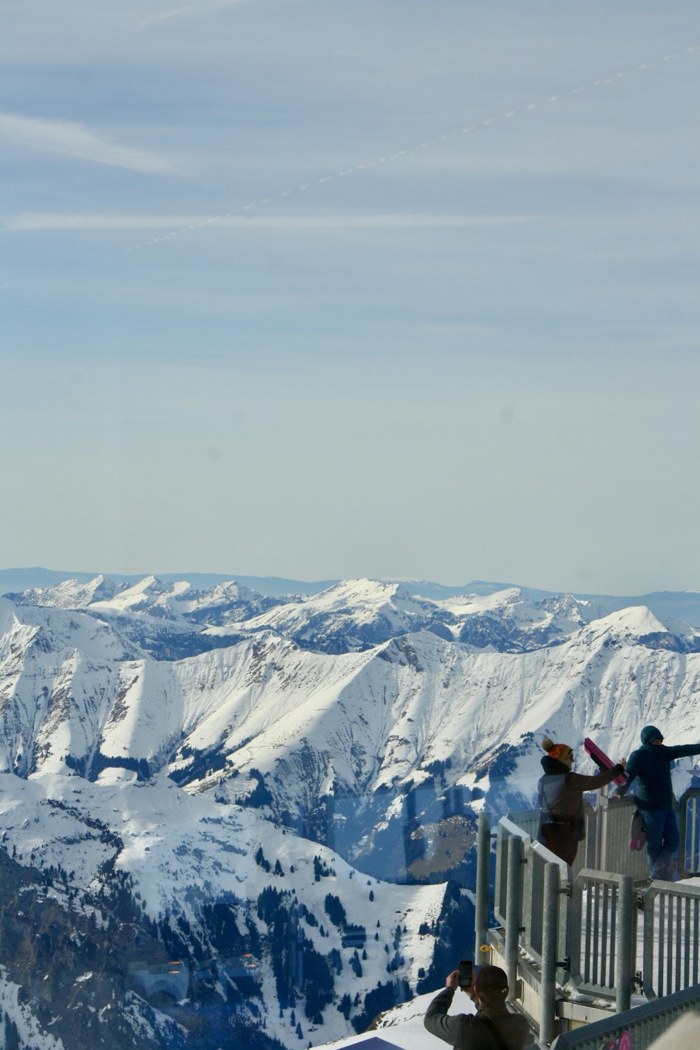 a group of people standing on top of a snow covered mountain