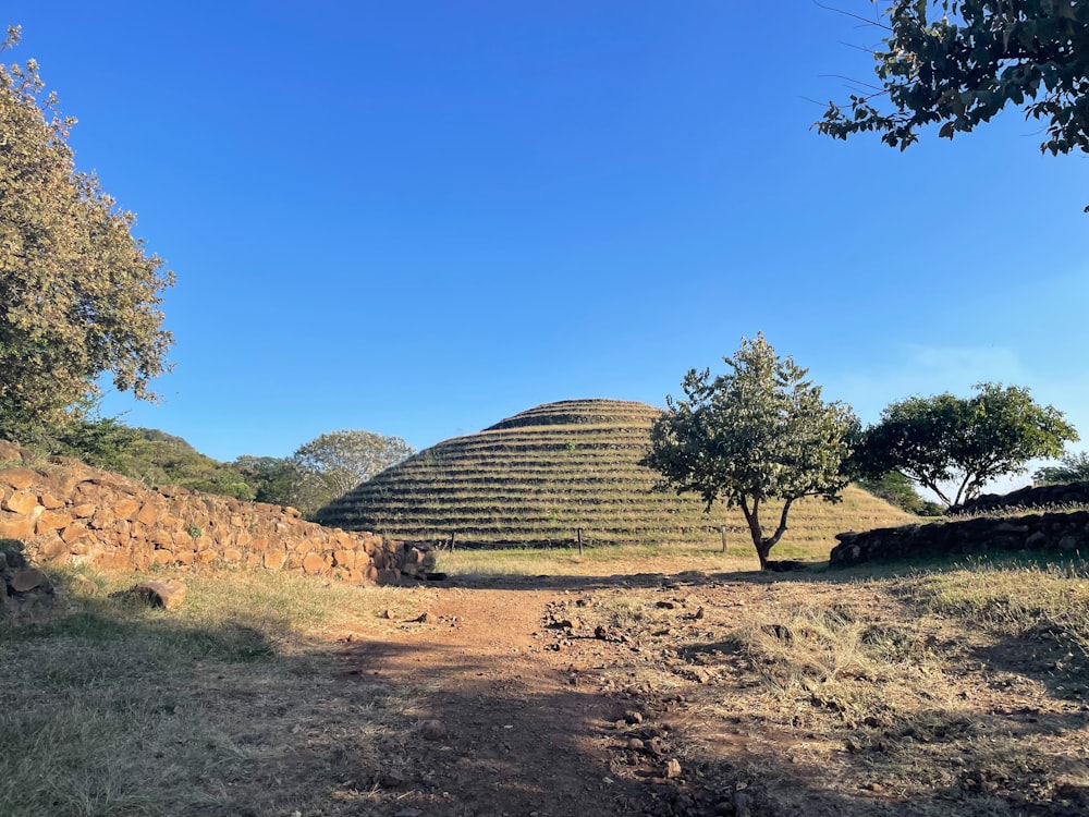 a large stone structure in the middle of a field