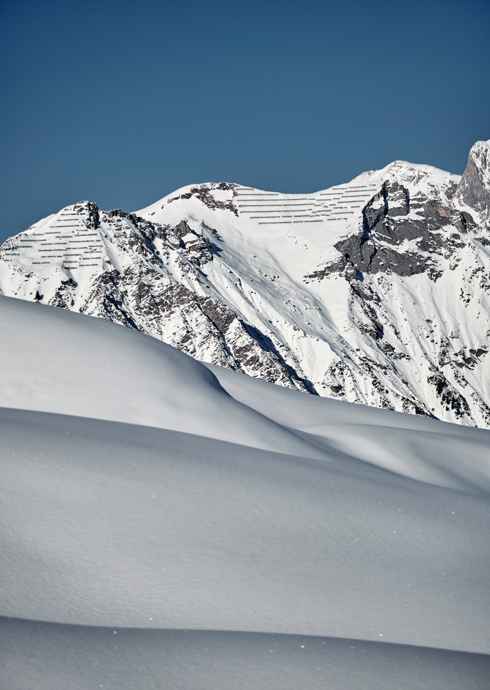 a person riding skis down a snow covered slope