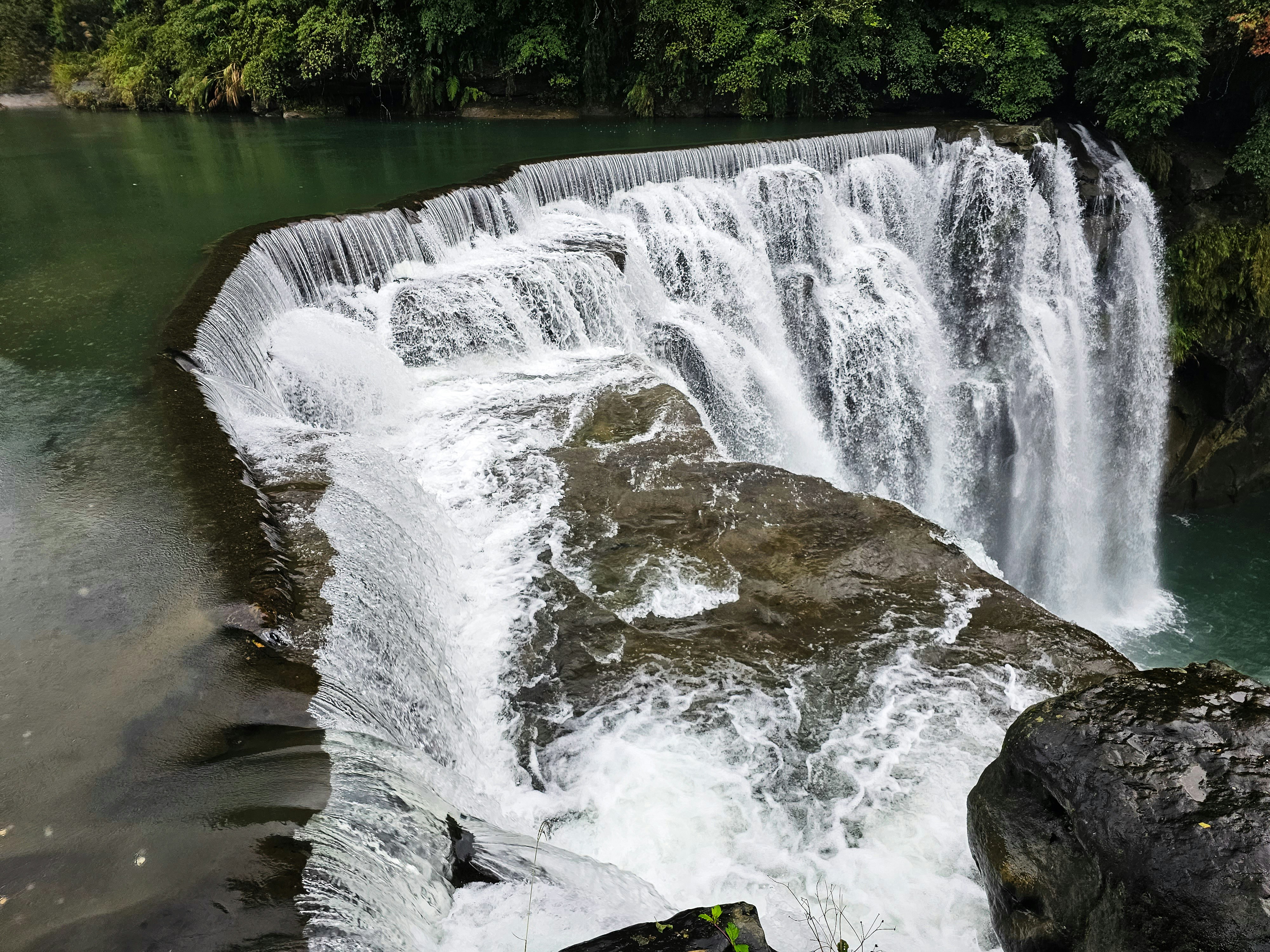 A waterfall with a large amount of water coming out of it photo – Free ...