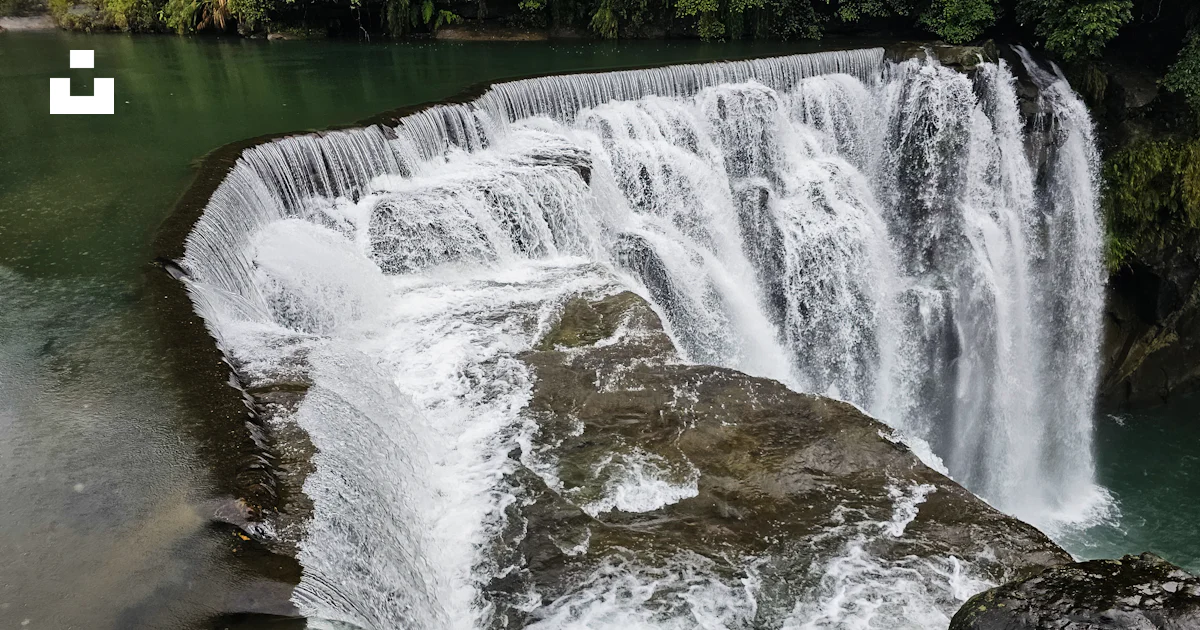 A waterfall with a large amount of water coming out of it photo – Free ...