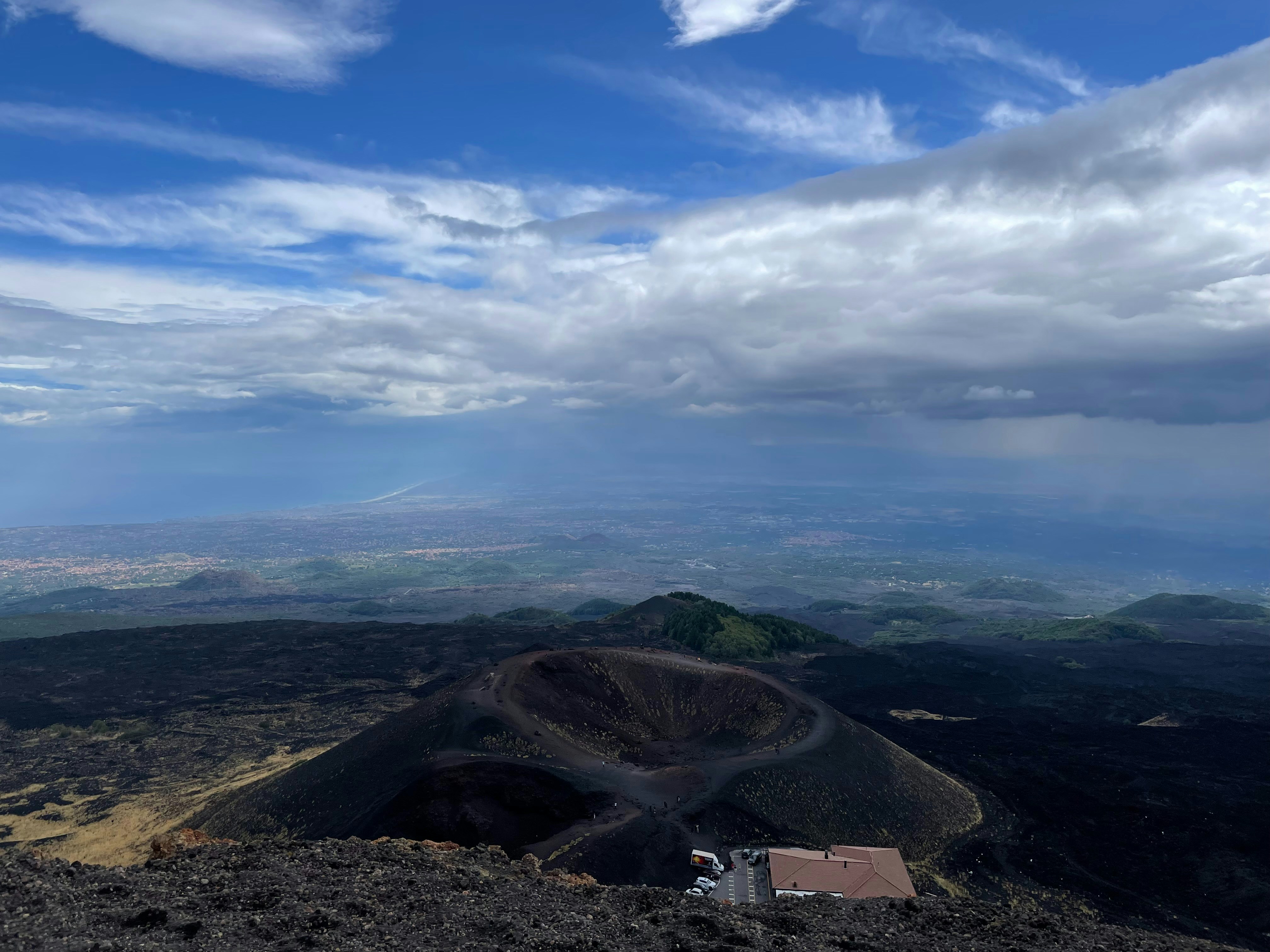 a view of a mountain with a house on top of it