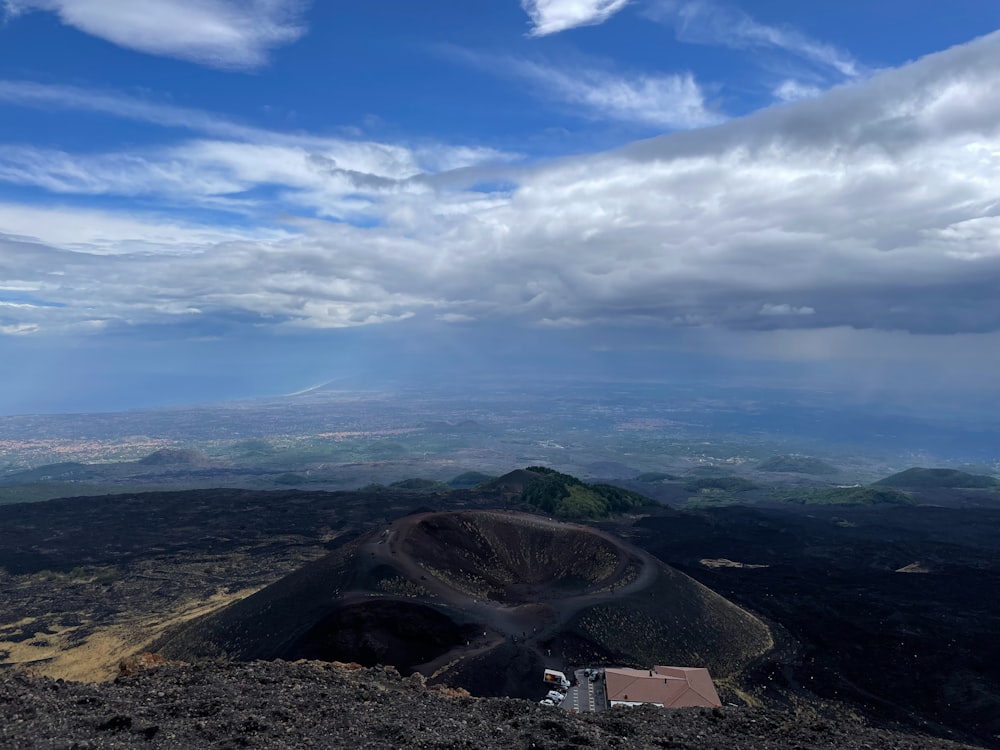 a view of a mountain with a house on top of it