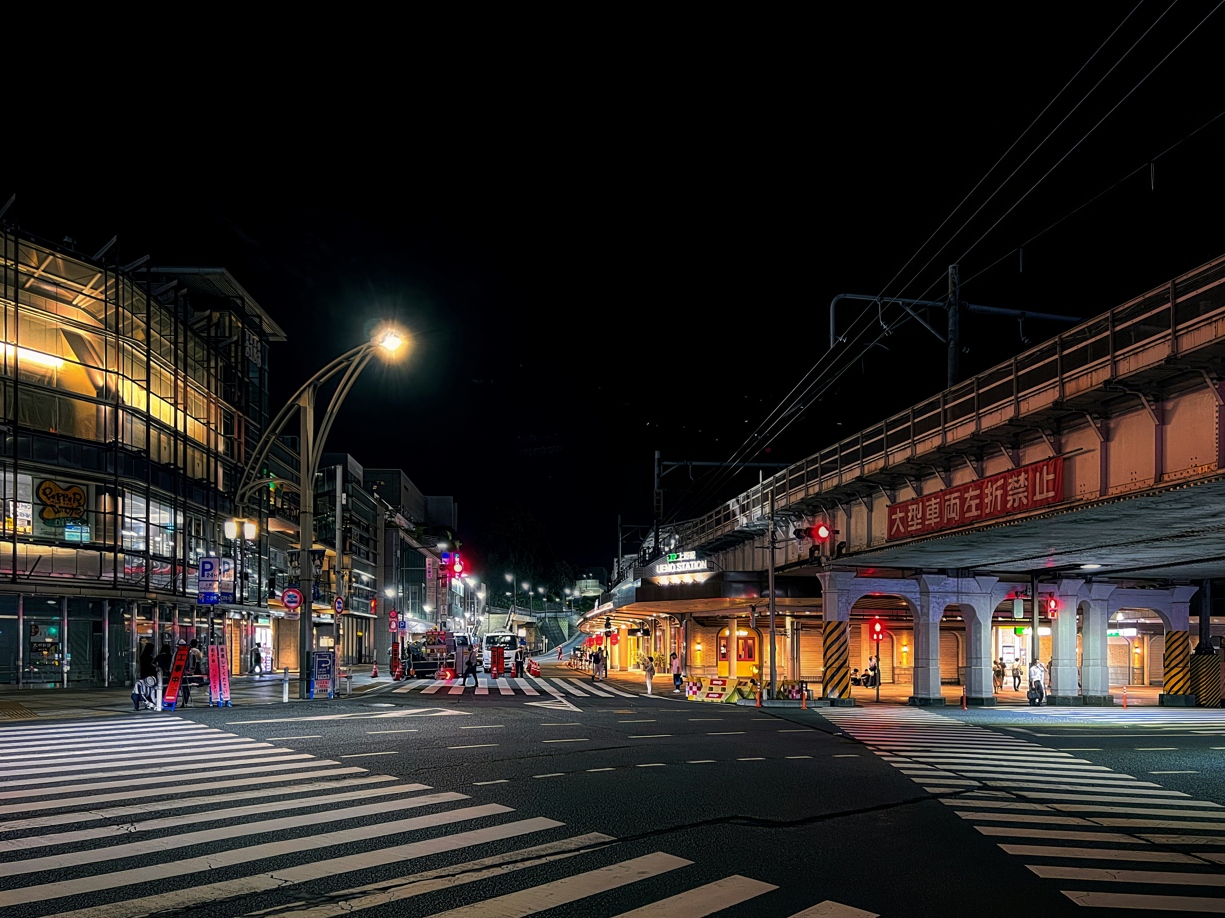 a city street at night with traffic lights