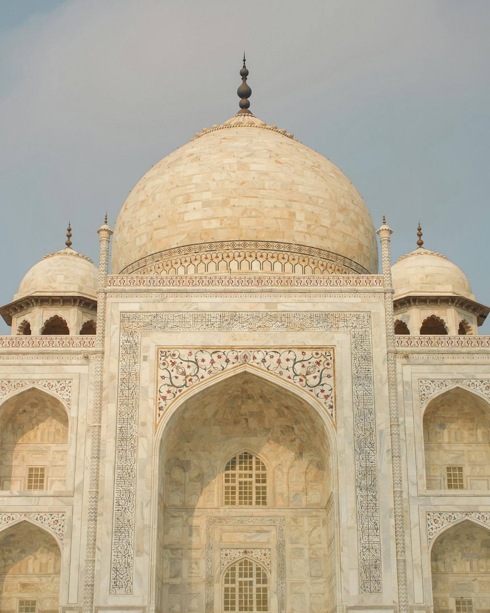 a large white building with arches and a dome