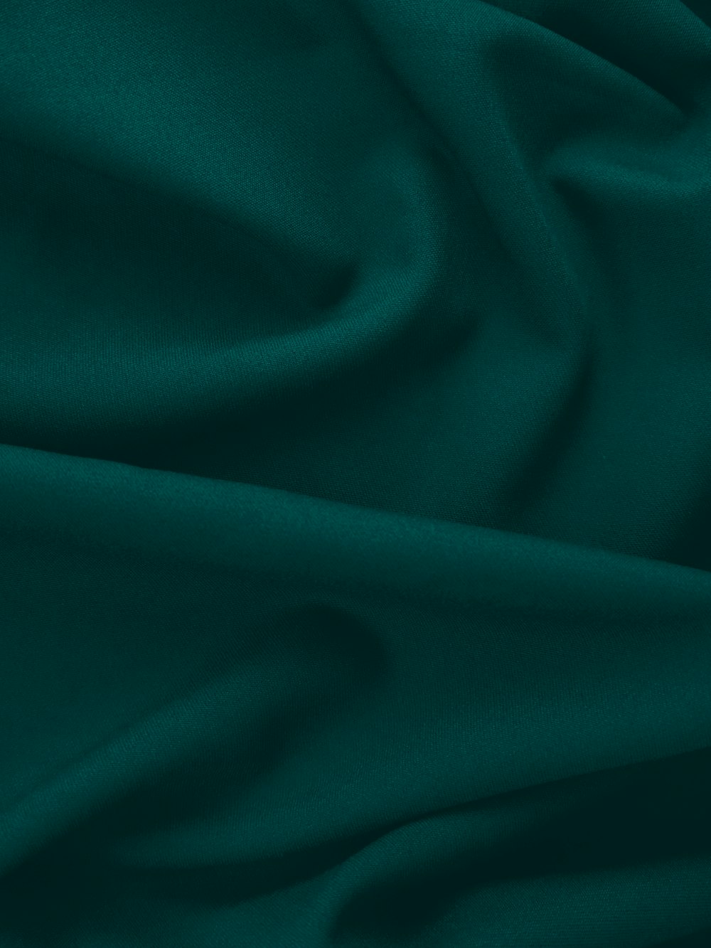 a close up of a dark green fabric