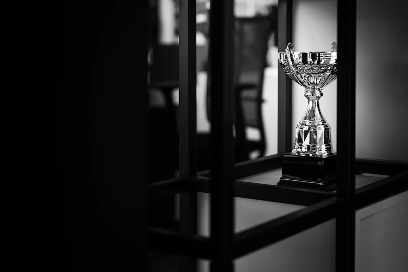 A silver trophy award with an engraved name plate