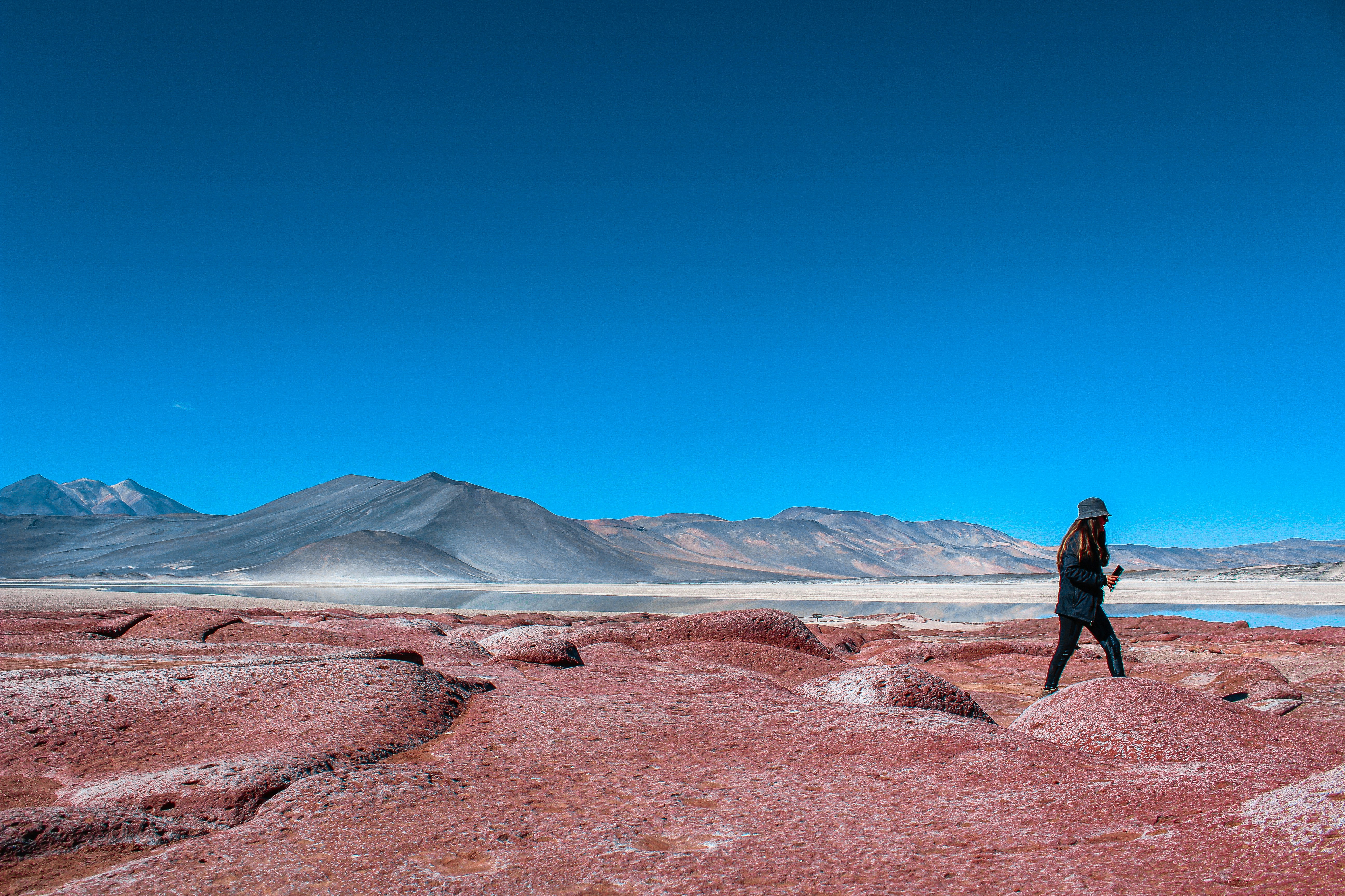 a person standing on top of a large rock
