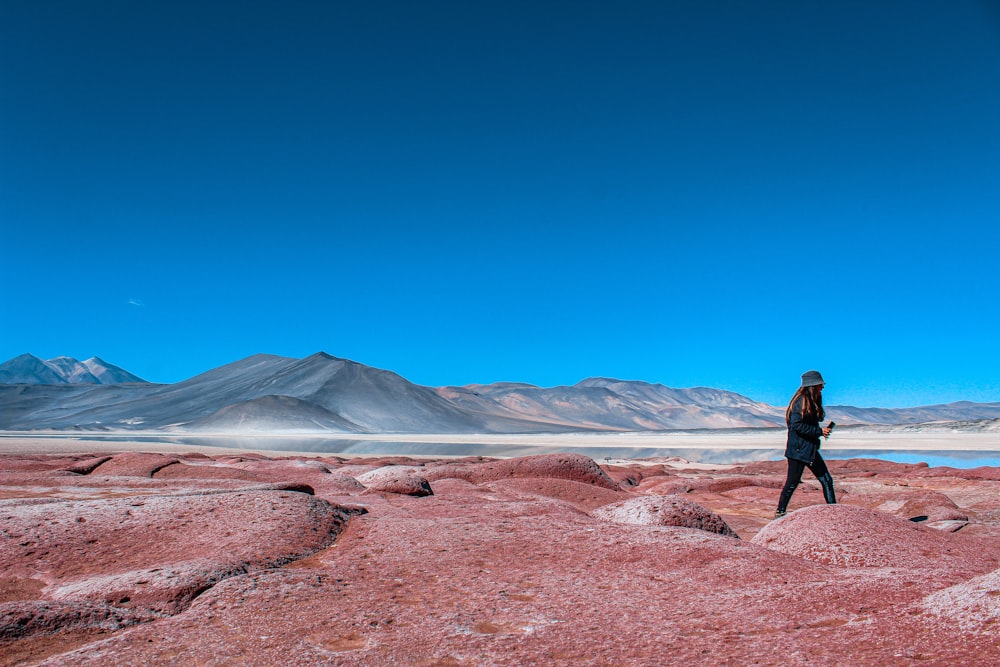 a person standing on top of a large rock