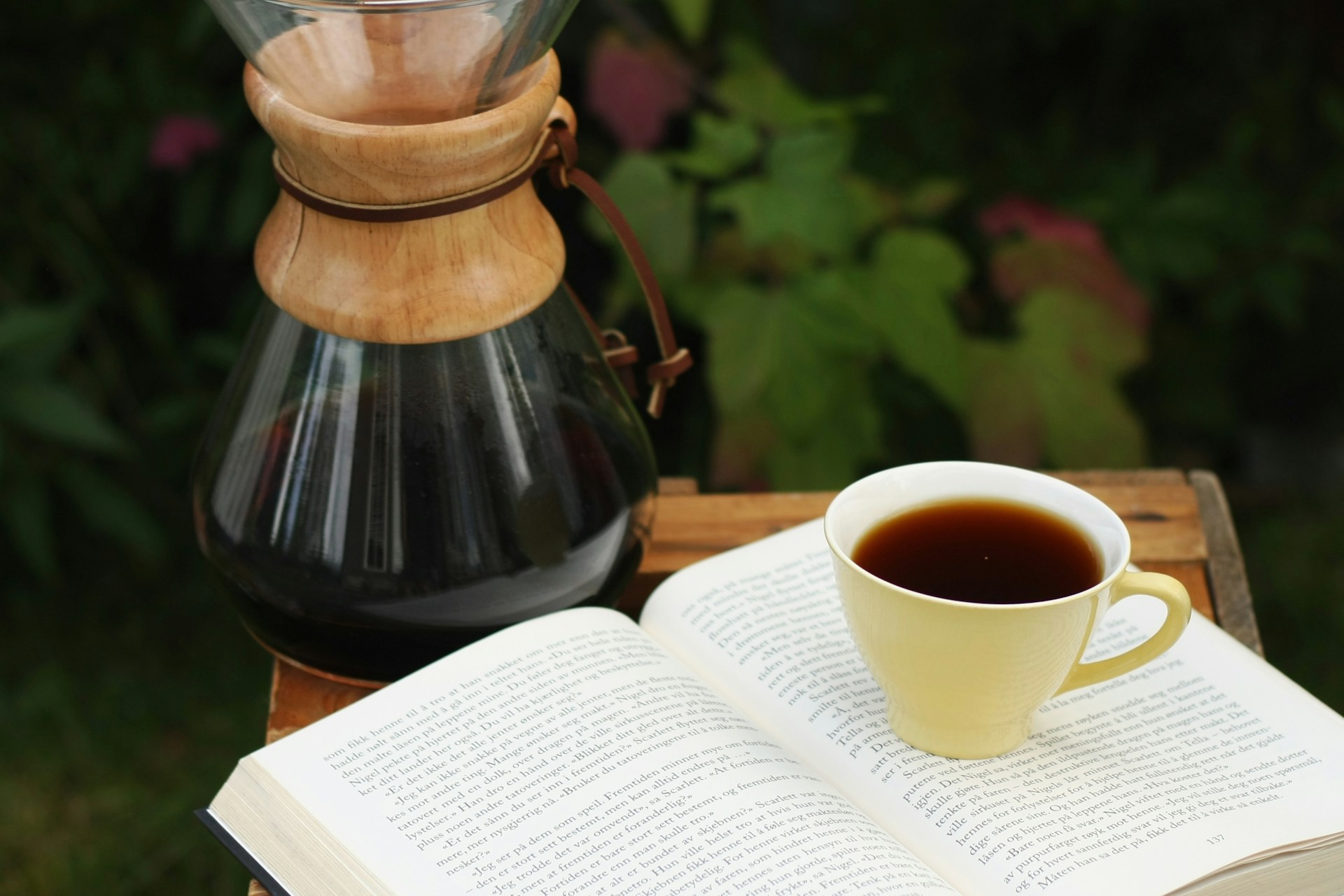 a cup of coffee and a book on a table