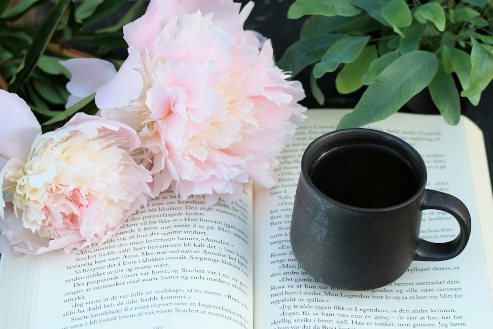 a cup of coffee and a book on a table