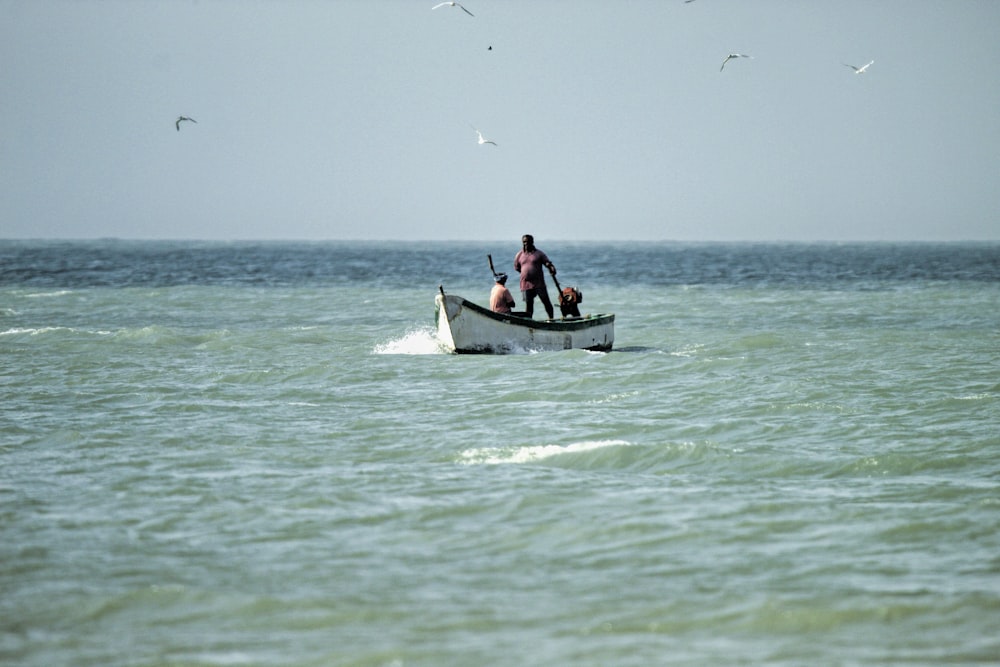 a man in a boat in the middle of the ocean