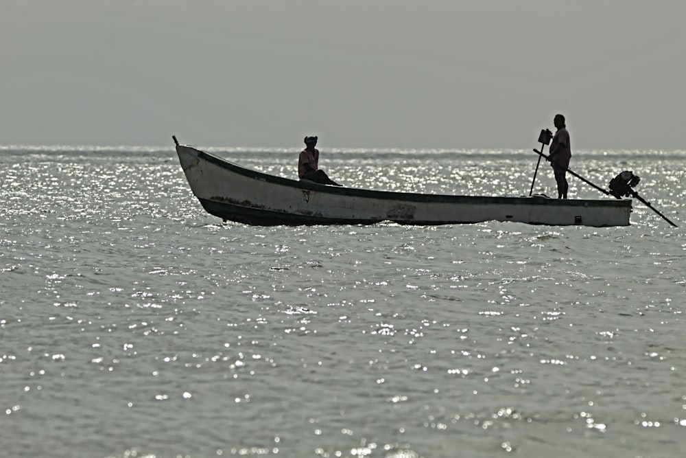 two people in a small boat on the water