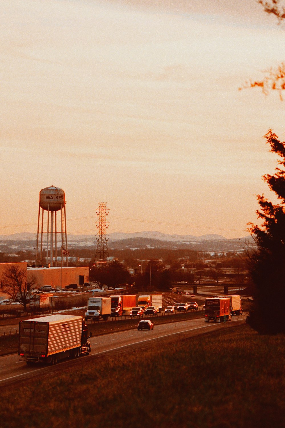 a traffic jam on a highway with a water tower in the background