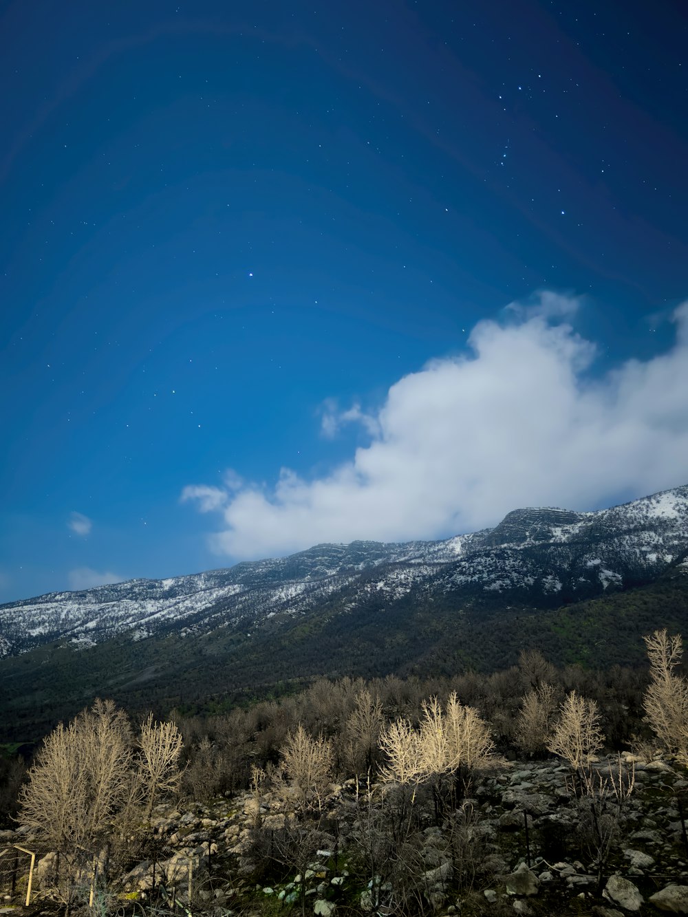 a snow covered mountain under a blue sky