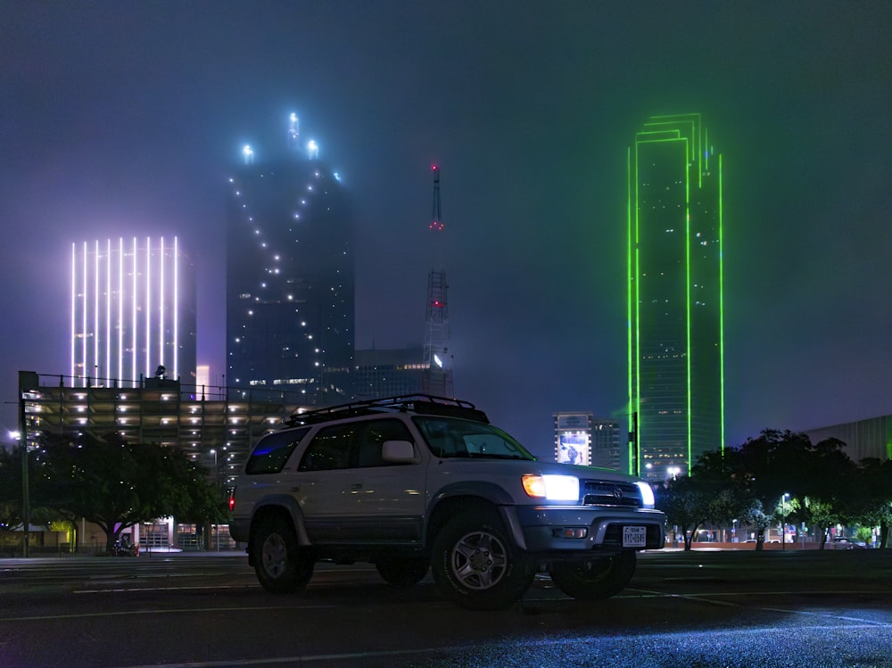 a suv parked in a parking lot at night