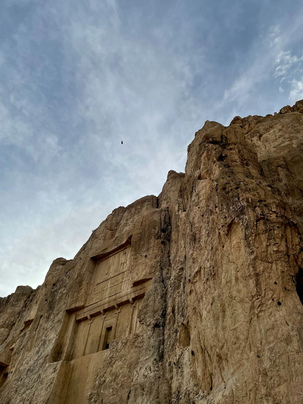 a large rock formation with a sky background