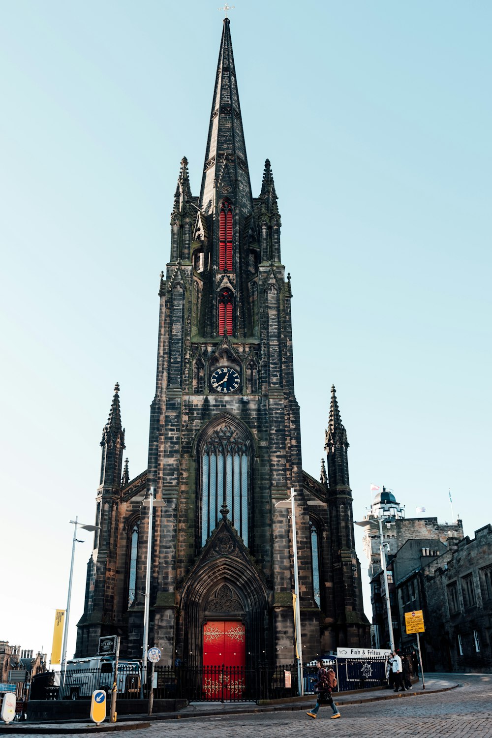 a very tall church with a clock on it's side