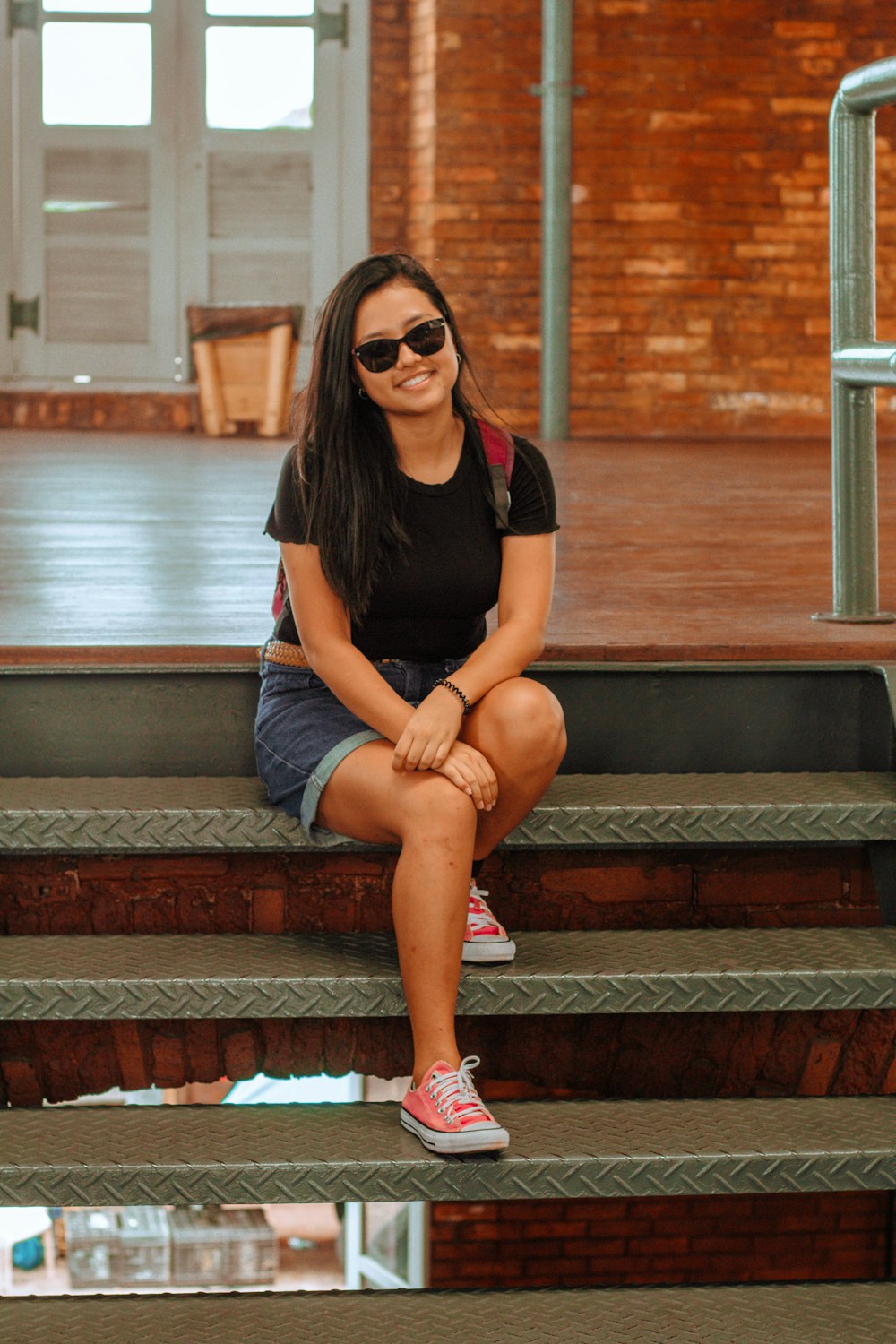 a woman sitting on the steps of a building