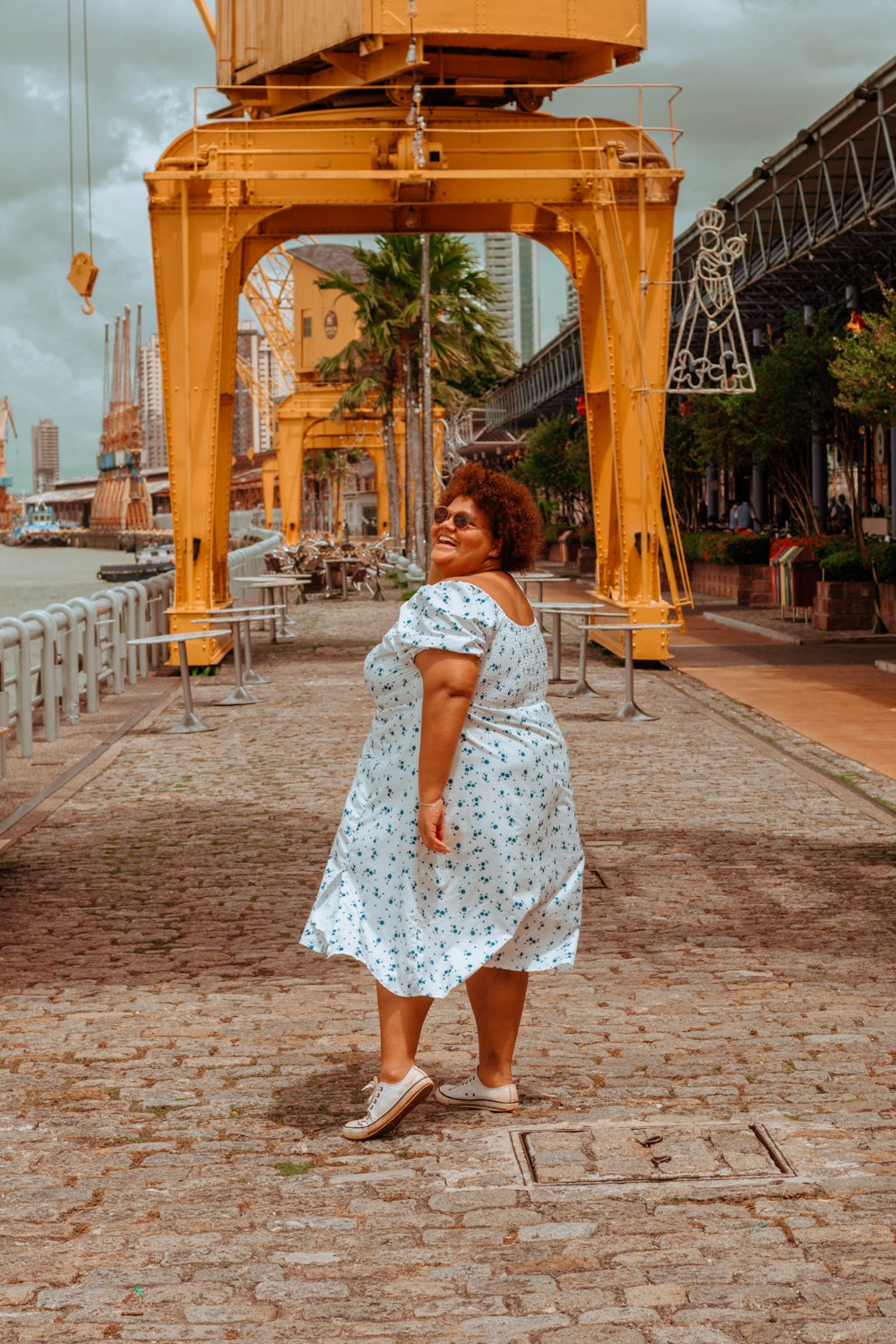 a woman standing in front of a yellow structure