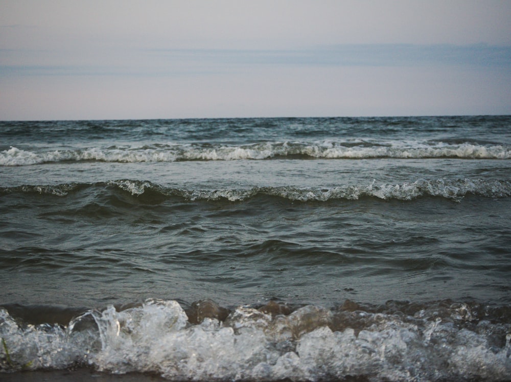 a body of water with waves coming in to shore