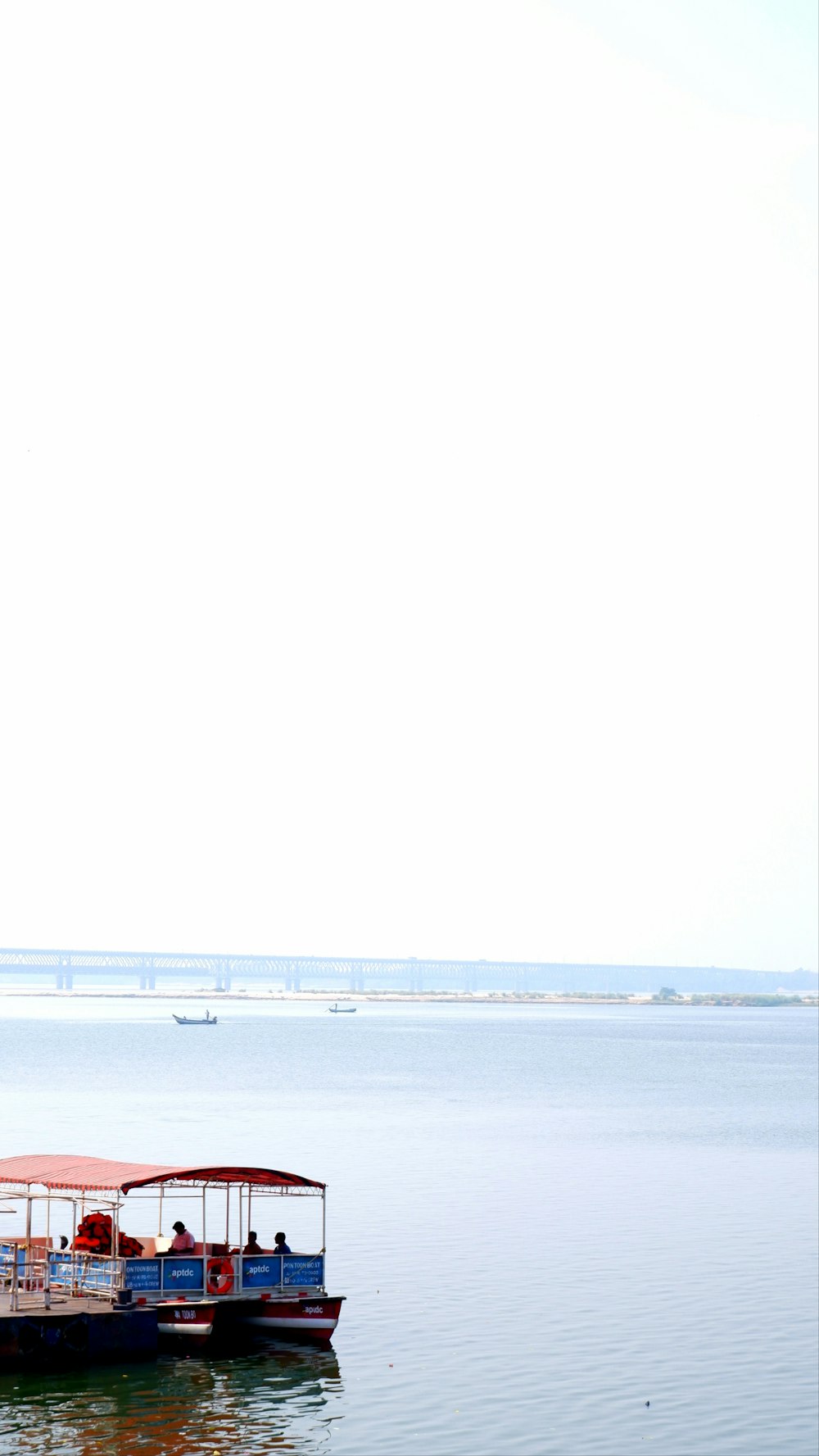 a boat with people on it floating in the water