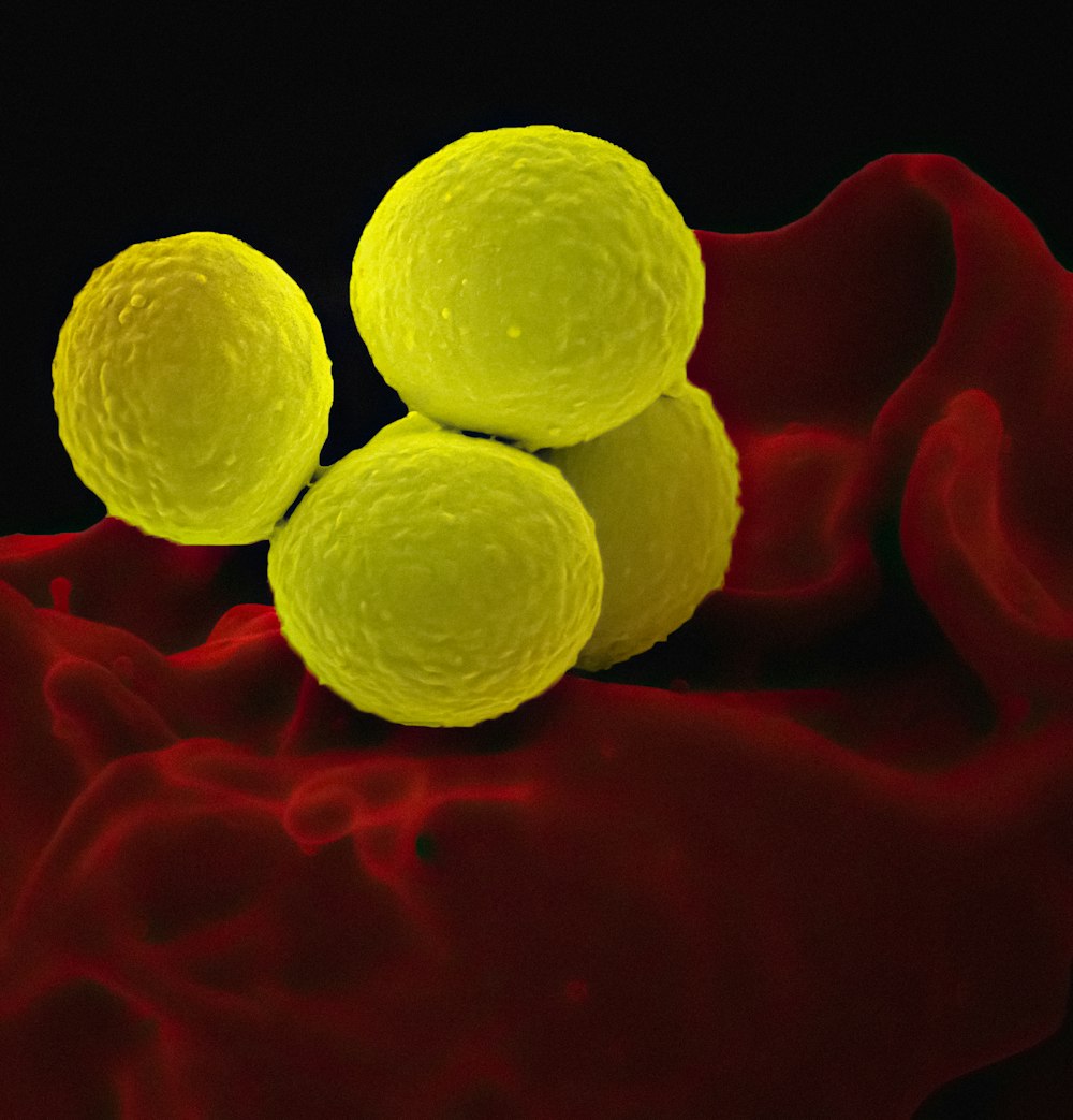 a group of three balls sitting on top of a red cloth