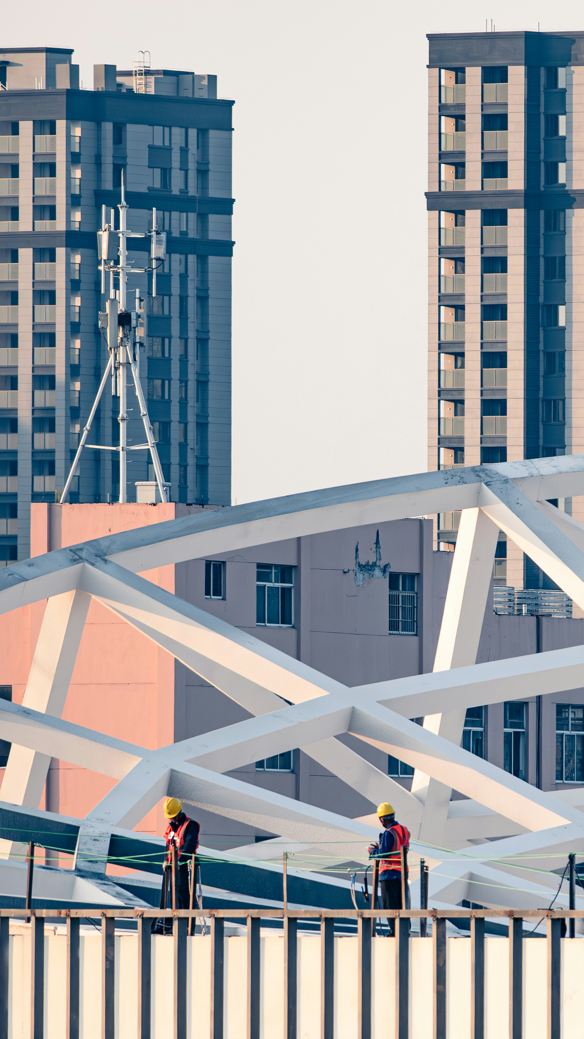 A couple of men standing on top of a bridge photo – Free Building Image ...